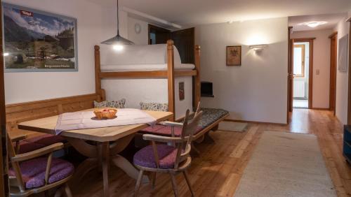 a dining room with a table and a bunk bed at Haus Christophorus in Mayrhofen