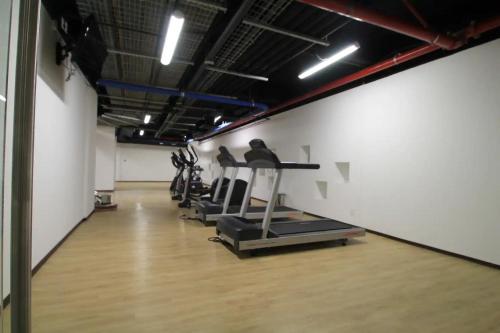 a gym with treadmills and cardio equipment in a room at Premier Apartment Downtown 4 Guests 1604 in Mexico City