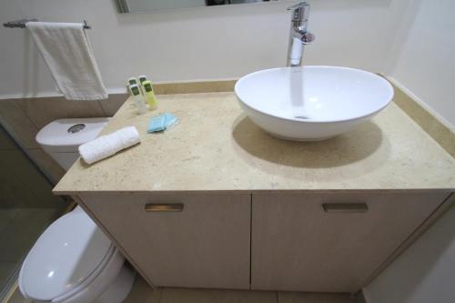a bathroom with a sink and a toilet at Premier Apartment Downtown 4 Guests 1604 in Mexico City