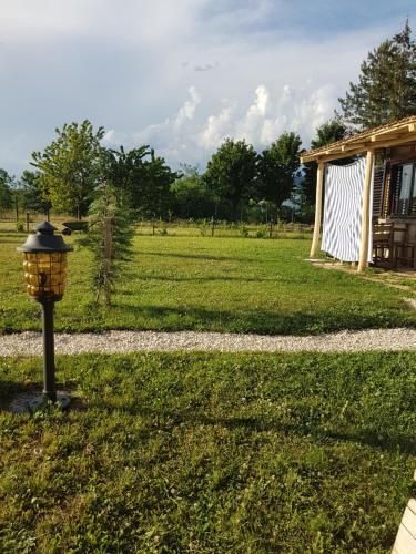 a street light in the grass next to a house at Belette Apartments & Park in Nikšić