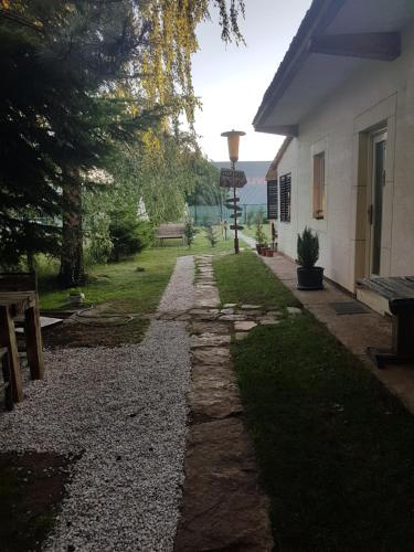 a stone path next to a house with a street light at Belette Apartments & Park in Nikšić