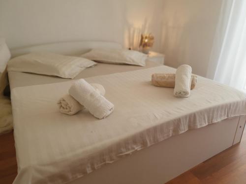 two towels are sitting on top of a bed at Villa Malena in Rab