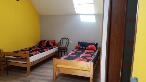 a small room with two beds and a couch at Pokoje Gościnne "U Karola" Pracownicze in Ścinawa