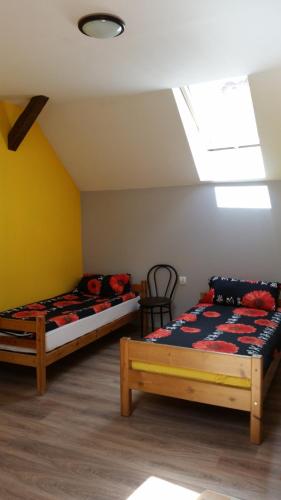 a bedroom with two beds and a skylight at Pokoje Gościnne "U Karola" Pracownicze in Ścinawa