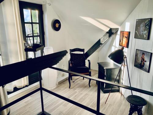 a room with a staircase with a chair and a window at Mollys in Hillerød