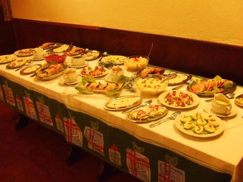 a table with many plates of food on it at Hotel Las Cascadas in La Cumbrecita