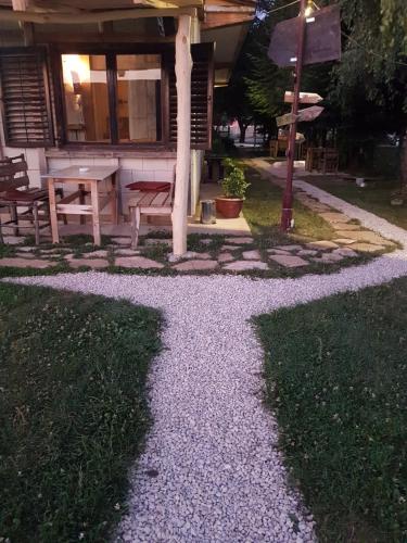 a gravel path in front of a house at Belette Apartments & Park in Nikšić
