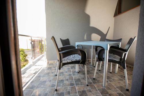 a table and chairs in a room with a window at Vila Todorović in Bela Crkva