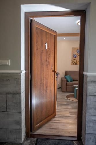 a wooden door in a room with a living room at Vila Todorović in Bela Crkva