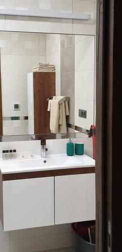 a white bathroom with a sink and a mirror at W sercu Srebrnej Góry in Srebrna Góra