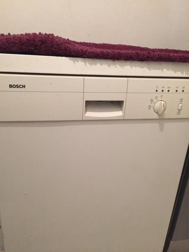a close up of a dishwasher at Belaire host appartment in Boumhel El Bassatine