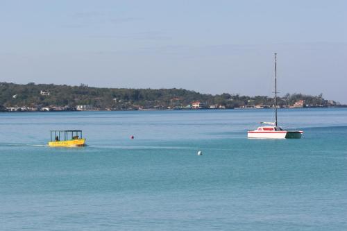 two boats floating on a large body of water at White Sands Negril in Negril