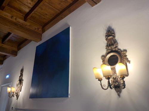 a light fixture on a wall in a room at Princess Art Hotel in Ferrara