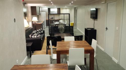 ein Zimmer mit Tischen und Stühlen und ein Wohnzimmer in der Unterkunft Rossio Suites in Lissabon