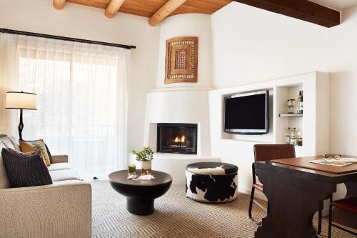 a living room with a table and a fireplace at Enchantment in Sedona