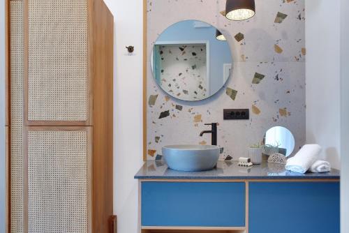 a bathroom with a blue sink and a mirror at Charisma Boutique Hotel in Parga