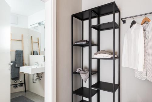 a black towel rack in a bathroom next to a sink at Villa Jasmine in Bolzano