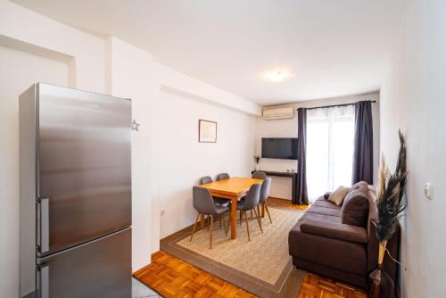 a living room with a couch and a table at Merita Apartments with Pool in Sveti Filip i Jakov