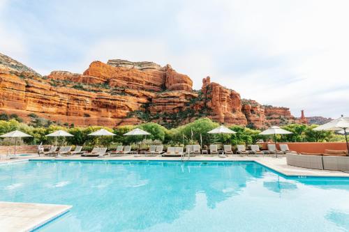 a beach with a pool and a waterfall at Enchantment Resort in Sedona