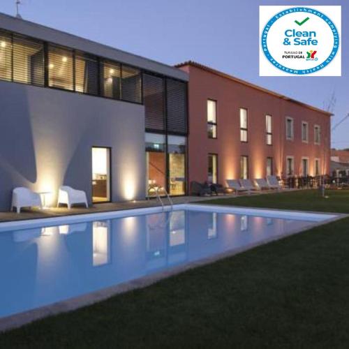 a swimming pool in front of a building at Casa de l Cura in Miranda do Douro