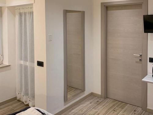 a door in a room with a mirror at Alloggio Casa Talvena Longarone in Longarone