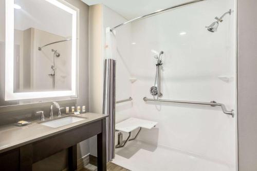 a white bathroom with a shower and a sink at La Quinta by Wyndham Ponca City in Ponca City