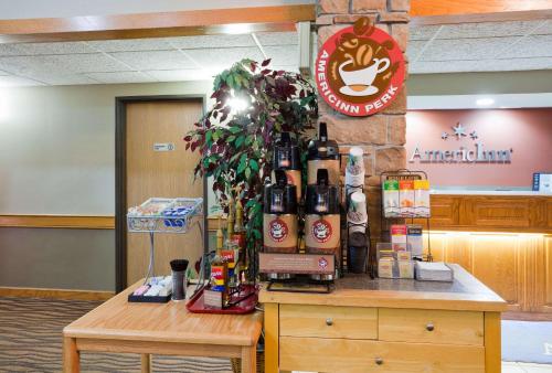 a counter with bottles of alcohol on top of it at AmericInn by Wyndham Coon Rapids in Coon Rapids