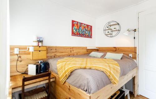 a bed in a room with a wooden wall at The Cabin at Zwolle Centraal in Zwolle