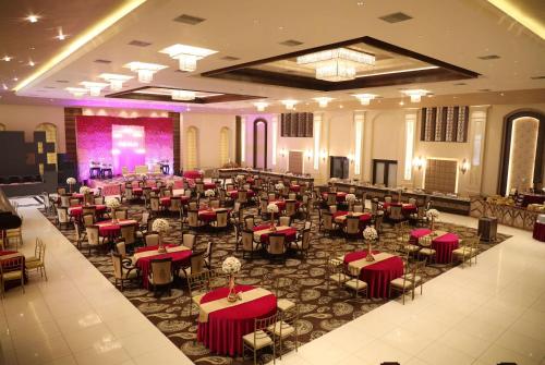a banquet hall with tables and chairs in a room at Ramada by Wyndham Kapurthala in Kapūrthala