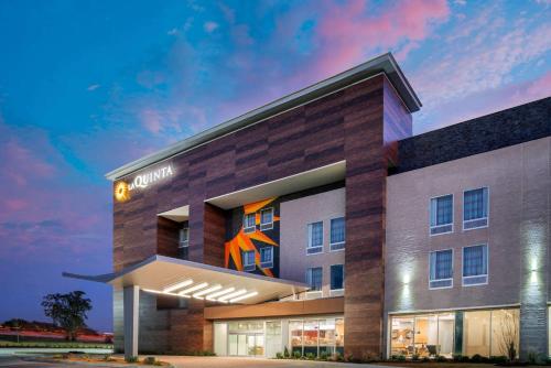 a rendering of the front of a hotel at La Quinta Inn & Suites by Wyndham Lewisville in Lewisville