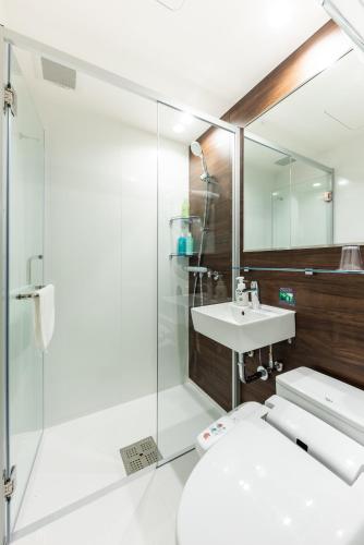 a bathroom with a toilet and a sink at Hotel Kazusaya in Tokyo