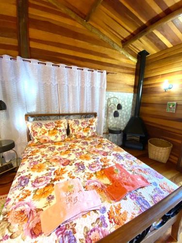a bedroom with a large bed in a room at Pousada Recanto da Siriema in Monte Alegre do Sul