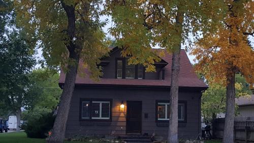 a black house with trees in front of it at Yellowstone House of the Three Bears 2 Blocks to Downtown in Cody