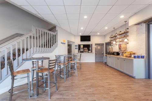 a bar with stools and a counter in a restaurant at Days Inn & Suites by Wyndham Lancaster Amish Country in Lancaster