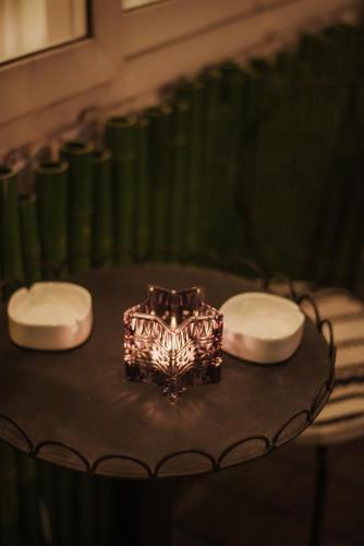 a cake on a table with two plates on it at Thang Long Opera Hotel in Hanoi