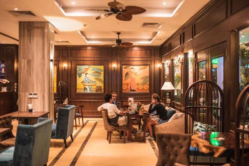 a group of people sitting at a table in a restaurant at Thang Long Opera Hotel in Hanoi