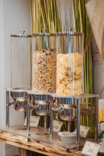a shelf with three containers of food on a table at Thang Long Opera Hotel in Hanoi