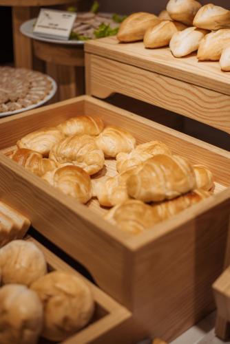 a bunch of breads in wooden trays in a bakery at Thang Long Opera Hotel in Hanoi