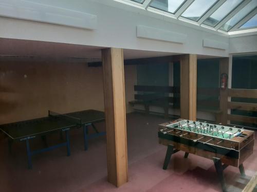 a room with two ping pong tables and a table at Apartment Anja in Schluchsee