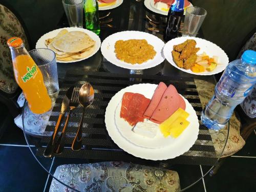 a table with plates of food on a table at Chic Apartment 2 in Sharm El Sheikh