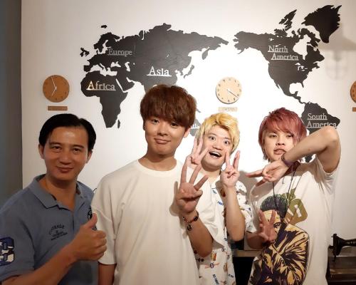 a group of people making the peace sign with their hands at 清淨背包客棧-民權館Quiet Hostel - Minquan Inn in Tainan