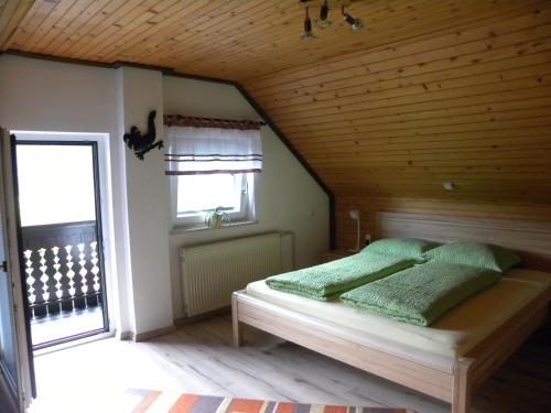 a bedroom with a bed with a wooden ceiling at Apartma Cvetek, Srednja vas 133 in Bohinj