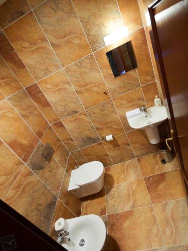 a bathroom with a toilet and a sink at Hradná stráž Hotel&Apartments s privátnym wellness in Topoľčianky