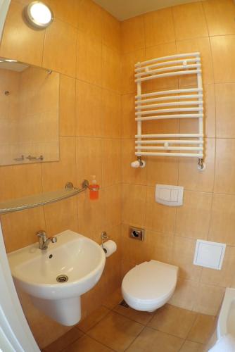 a bathroom with a white toilet and a sink at Nawojka Hotele Studenckie in Kraków