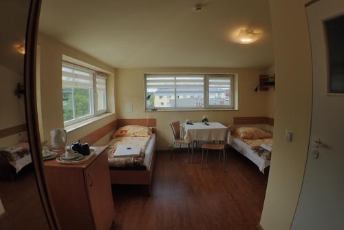 a room with two beds and a table in it at Nawojka Hotele Studenckie in Kraków