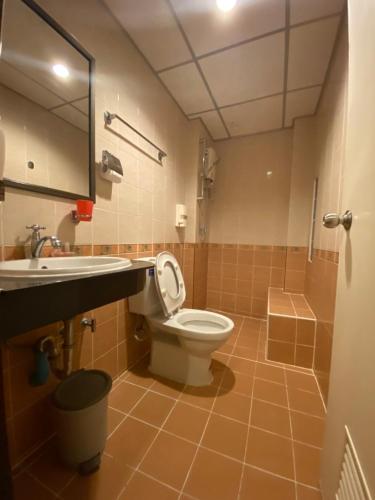 a bathroom with a toilet and a sink at Honey House 2 in Bangkok