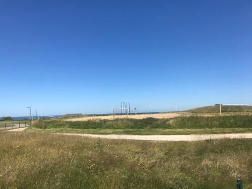 a dirt road in the middle of a field at Camping De Collignon in Cherbourg en Cotentin