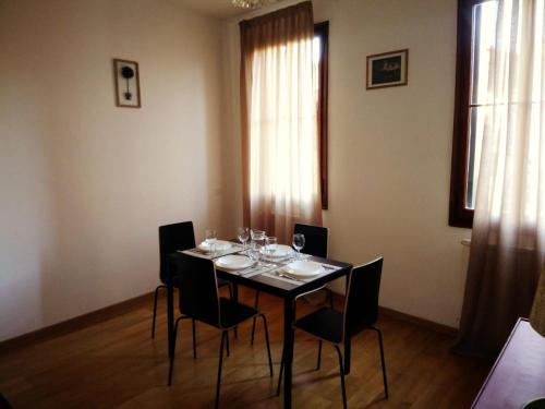 a dining room table with chairs and wine glasses on it at Ca' Dorso in Venice