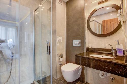 a bathroom with a toilet, sink, and shower at Violin Boutique Hotel in Istanbul