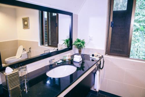 a bathroom with a sink and a large mirror at Mutiara Taman Negara in Kuala Tahan